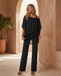 Model wearing an asymmetrical layered top with matching wide-leg trousers.