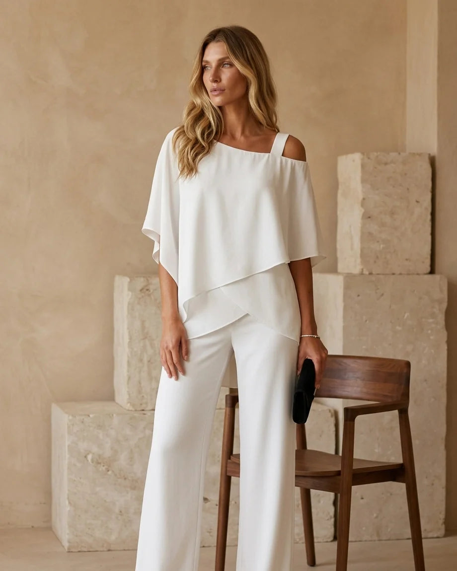 Model wearing an asymmetrical layered top with matching wide-leg trousers. - 4