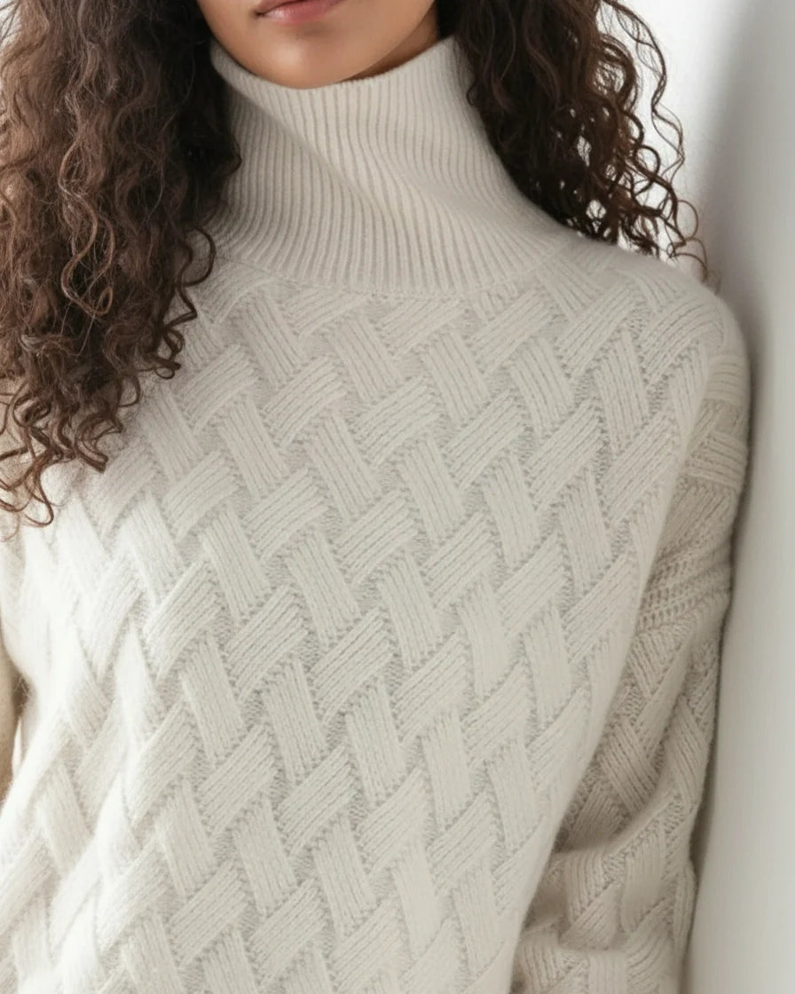 Woman wearing a beige relaxed-fit turtleneck sweater with a textured basketweave knit pattern. - 4