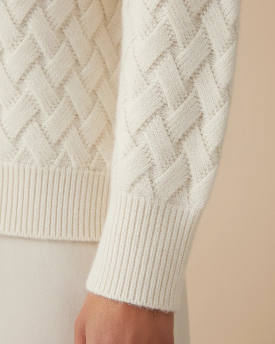 Woman wearing a beige relaxed-fit turtleneck sweater with a textured basketweave knit pattern. - 5