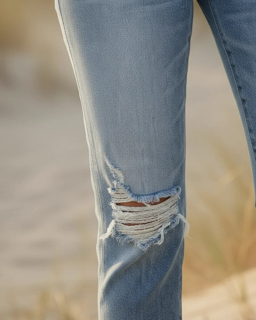 Light blue high-waist skinny denim jeans with distressed knee rips and frayed hems. - 7