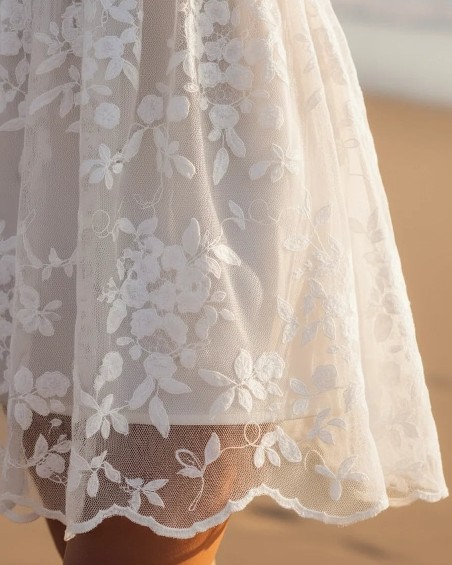 Sleeveless white mini dress featuring floral lace overlay, V-neckline, and scalloped hem. - 4