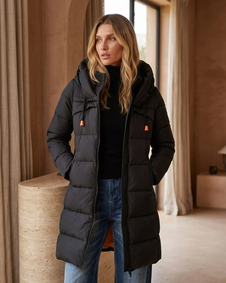 A black long-sleeve midi puffer coat featuring horizontal quilting, a large drawstring hood with orange accents, and a front zipper.