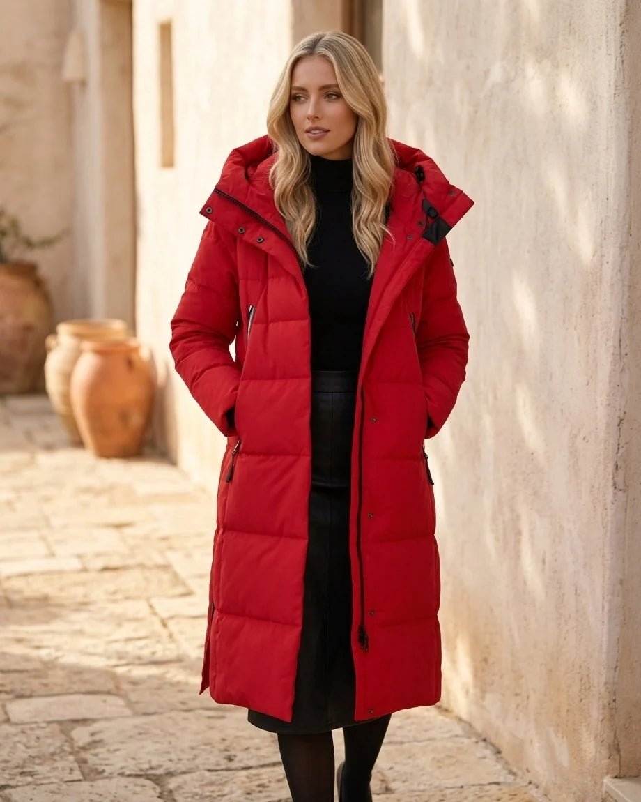 Midi-length quilted puffer coat with a large hood and side zipper details.