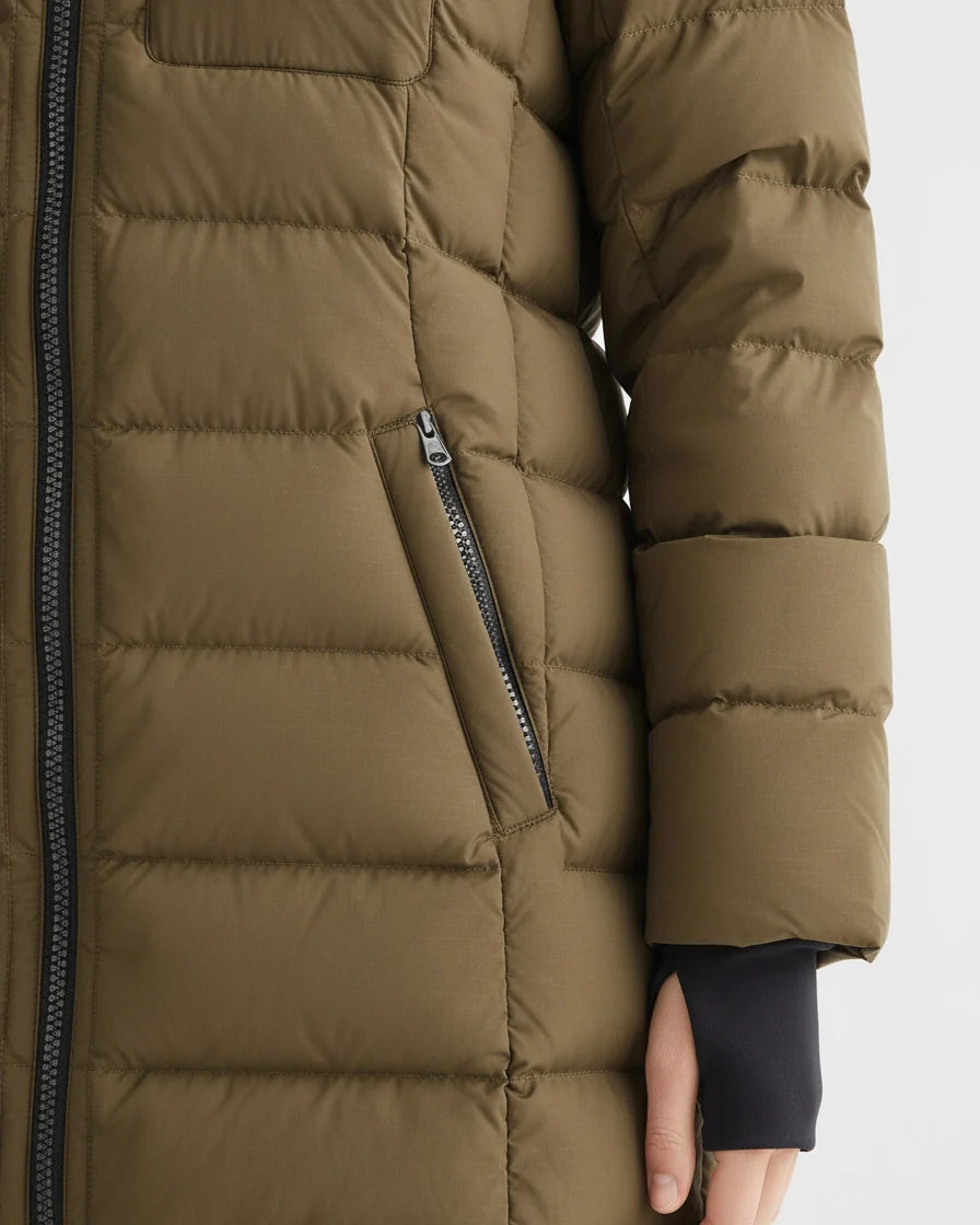 Mid-length olive green quilted puffer coat with a hood and black zipper details on a model. - 8