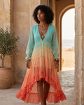 Long sleeve maxi dress with blue, yellow, and coral ombre tones and a tiered ruffled skirt.