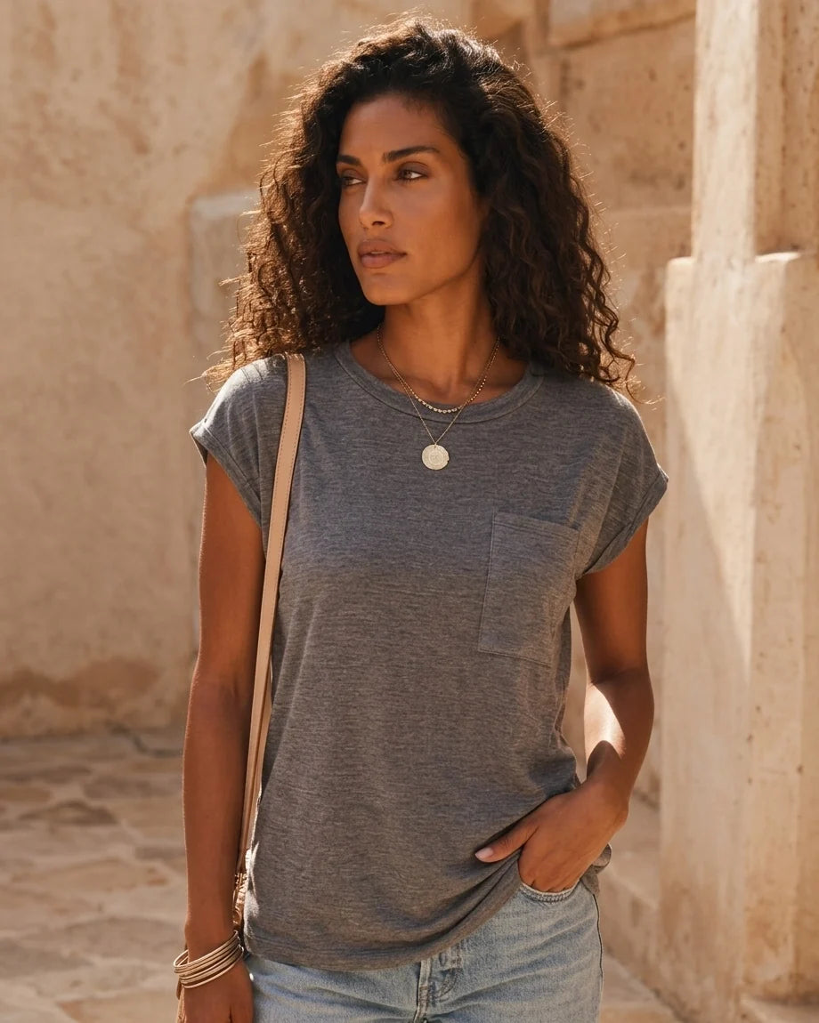 A woman wearing a relaxed-fit short sleeve crew neck t-shirt with a chest patch pocket.