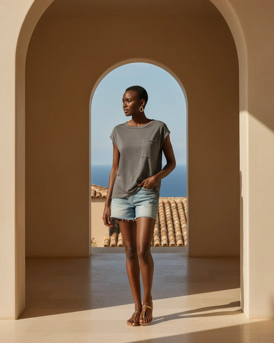 A woman wearing a relaxed-fit short sleeve crew neck t-shirt with a chest patch pocket. - 2