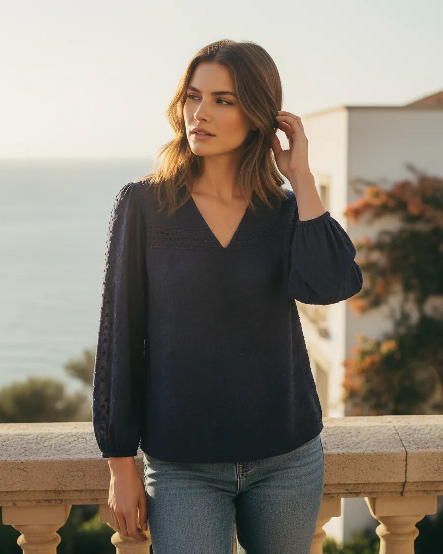 Woman wearing a V-neck lace blouse with long sleeves and a soft drape - Navy Blue