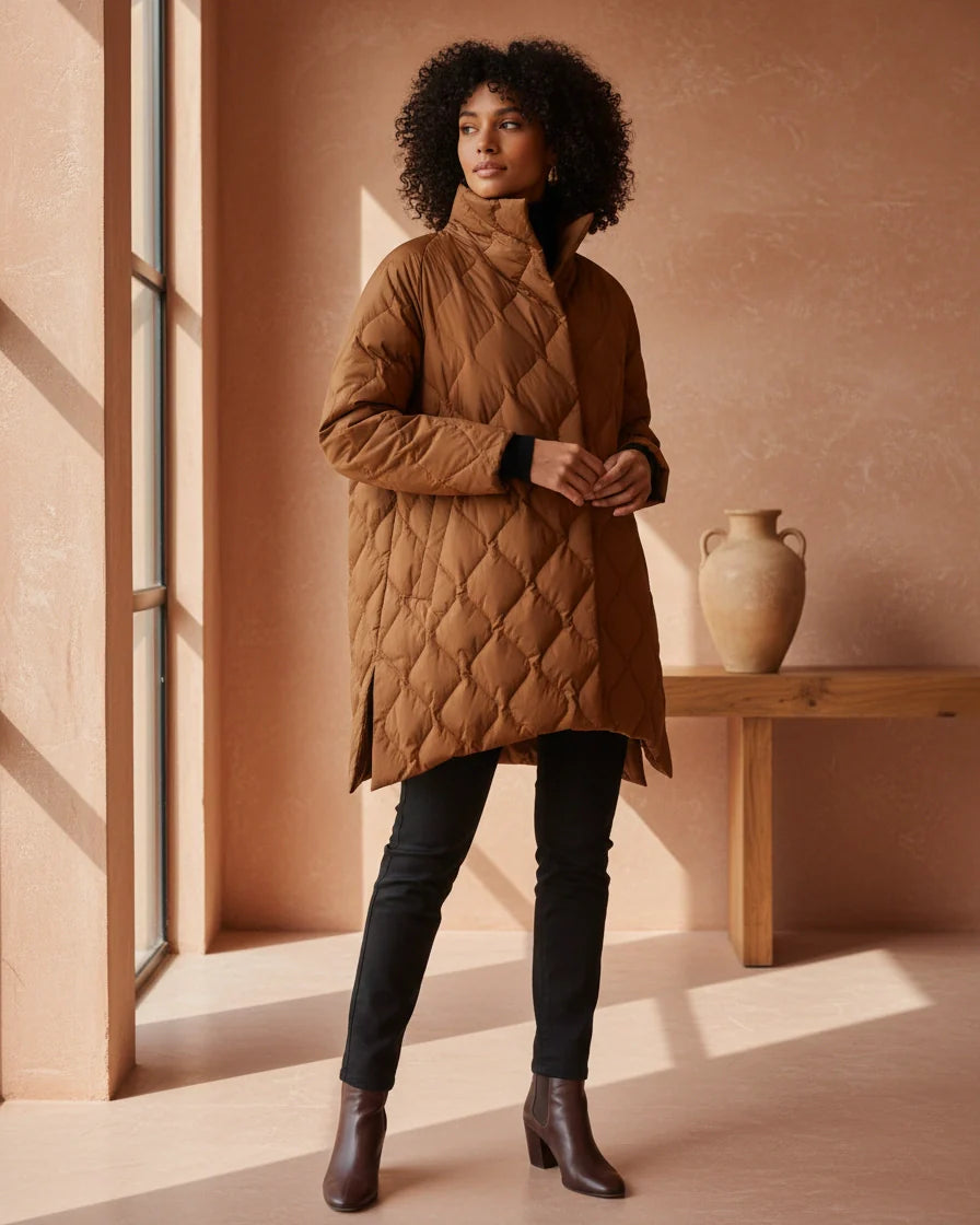Black diamond quilted puffer jacket with a high stand collar and snap closures on a model. - 3