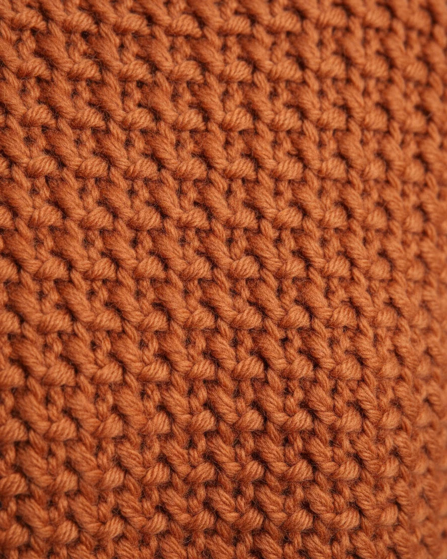 Model wearing a relaxed orange knit sweater with a mock neck and drop shoulders. - 8