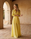 Yellow cotton-linen blend maxi shirt dress featuring a deep V-neckline, half sleeves with cuffed detail, and a wide fabric sash at the waist.